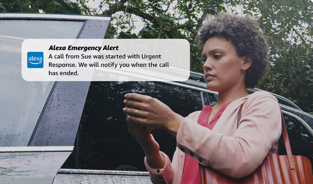 promotional photo of a woman reading an alert sent by Alexa Emergency Assist