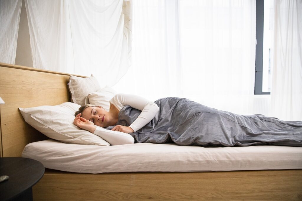 photo of a woman sleeping with bed bugs hiding nearby