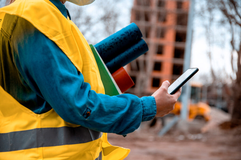 photo of a contractor using an app for his construction business