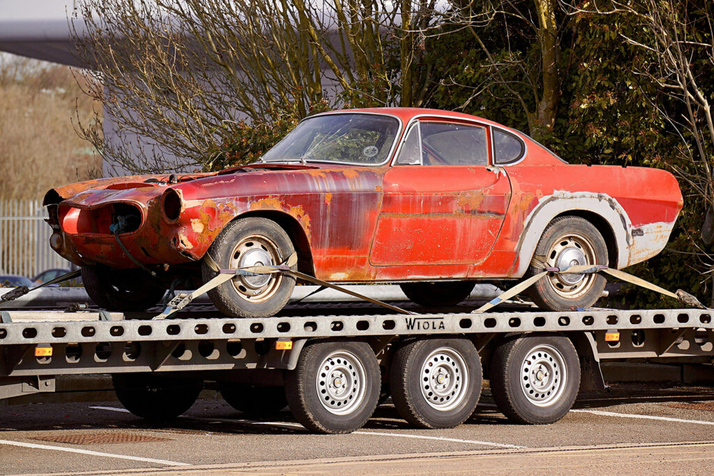 photo of a junk car on a truck flatbed