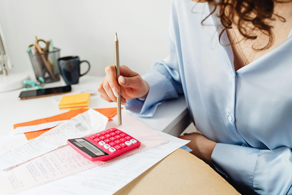 photo of a woman calculating the price of her home for sale