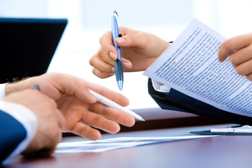 photo of people signing legal documents