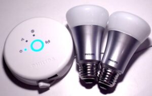 Philips Hue Smart Light Bulbs on the right, with a controller hub on the left.