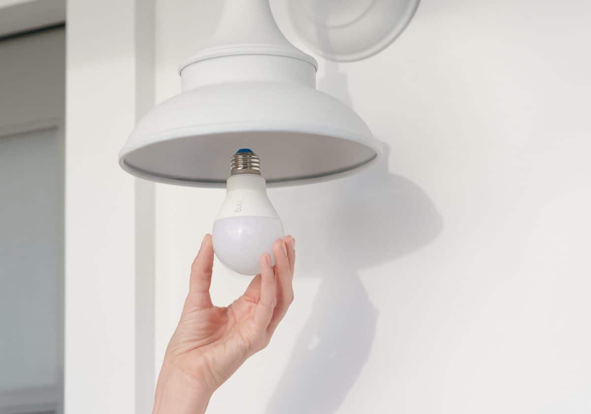 A Ring A19 smart light bulb being installed