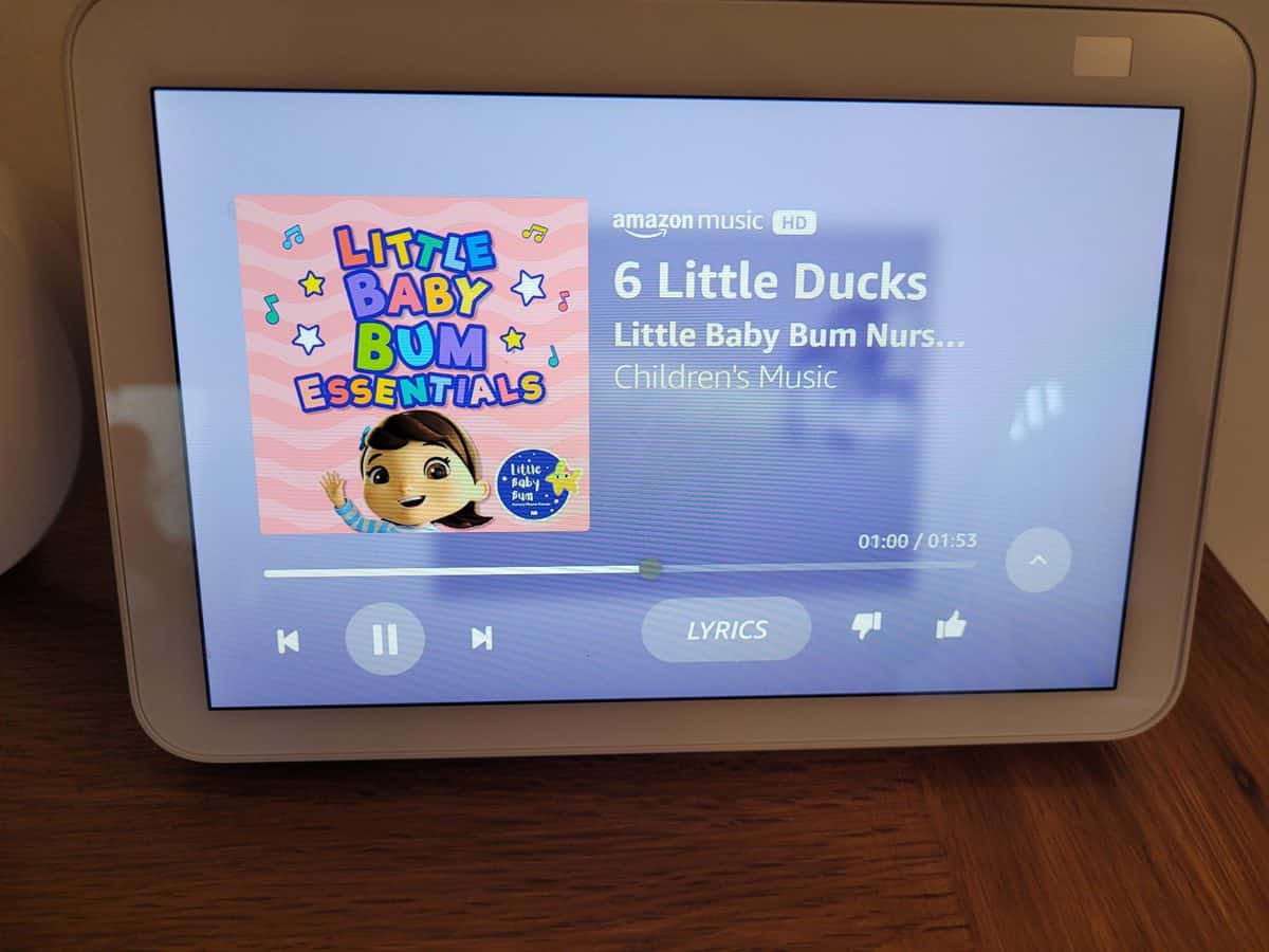 A song playing on an Amazon Echo Show with the Lyrics button at the bottom