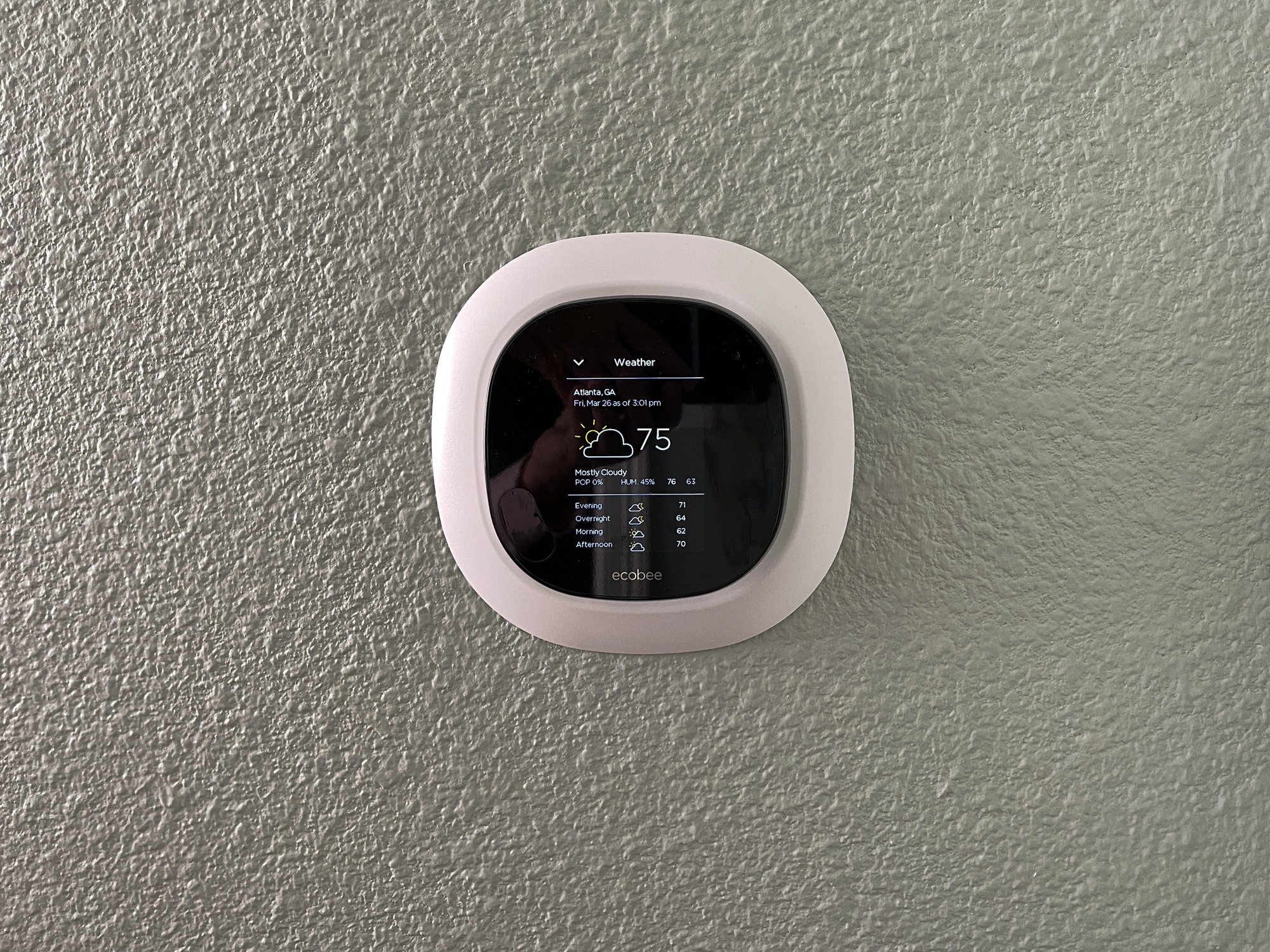 An Ecobee smart thermostat displaying the current weather