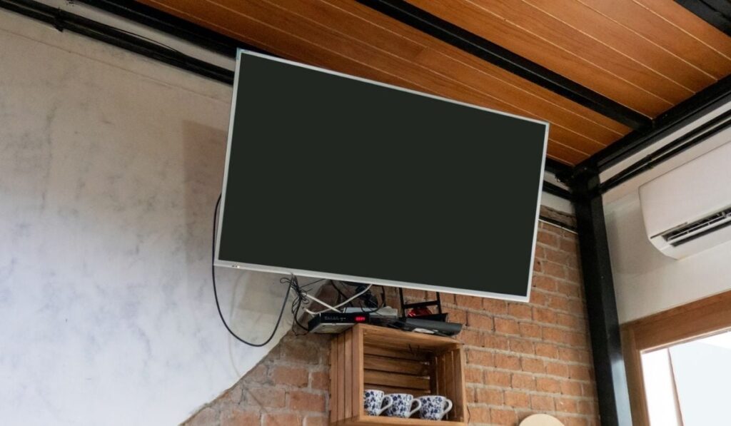 Flat TV hanging on brick wall