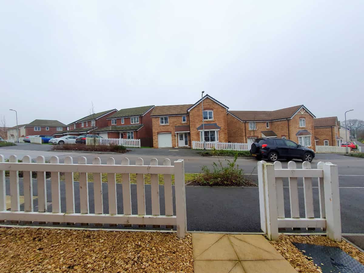 A photo (taken with a wide angle lens) of the front of my property - with it only having 5 ft (1.5m) of distance between the front door and the sidewalk. The road is therefore not too far from the front of the house.