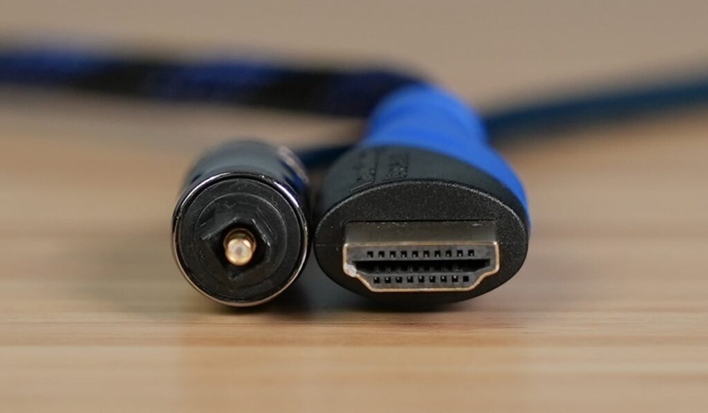 HDMI Cable and Digital Optical Cable on a wooden desk