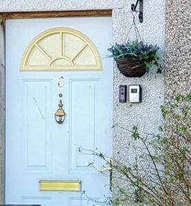 A door with a narrow frame, leading to a Ring doorbell being installed on the wall instead.