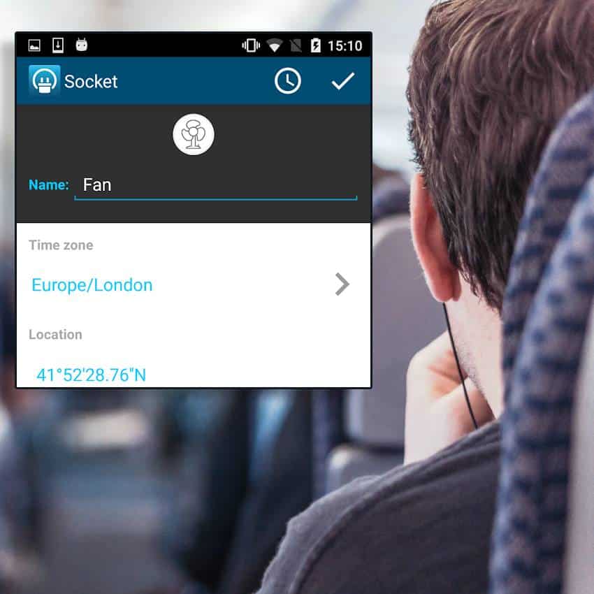 A smart plug phone app on top of a person on a train.