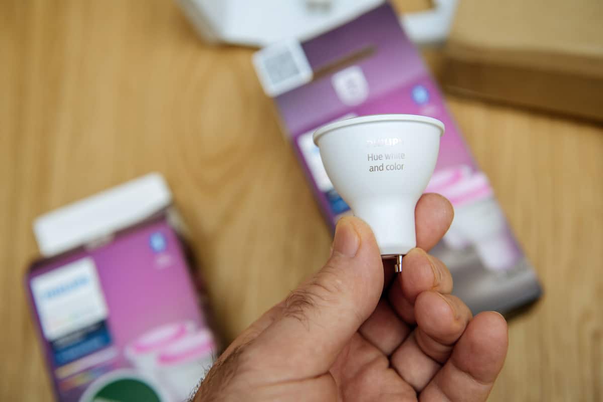 Someone holding a 2nd gen Philips Hue Gu10 bulb