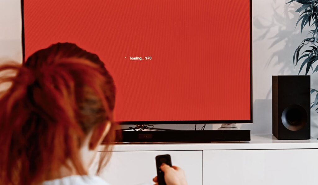 Woman controlling a soundbar and tv