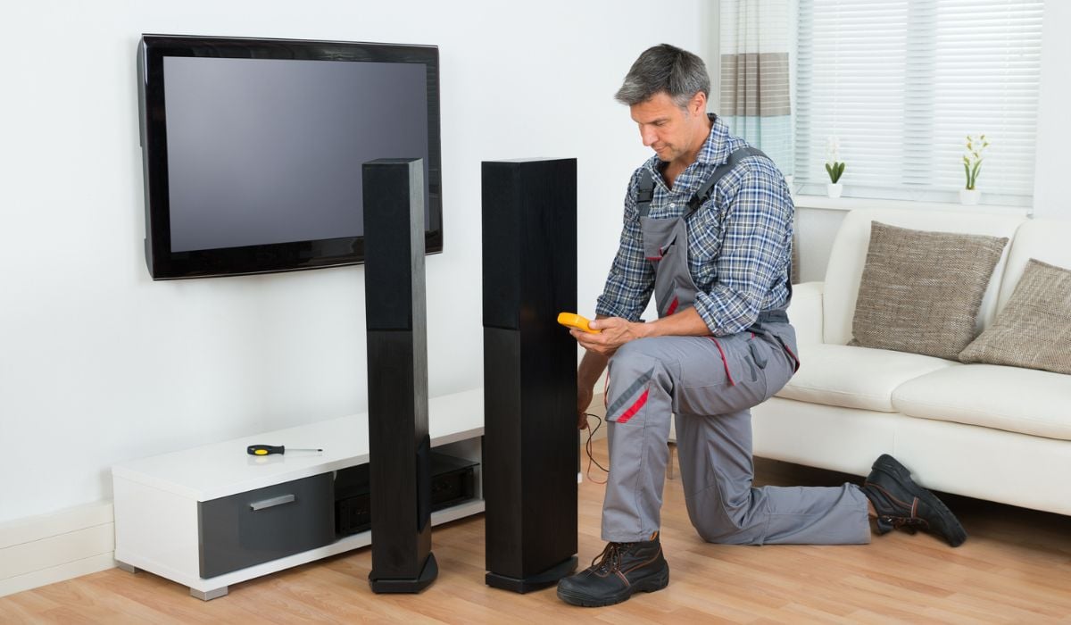 Technician Checking TV Speaker With Multimeter