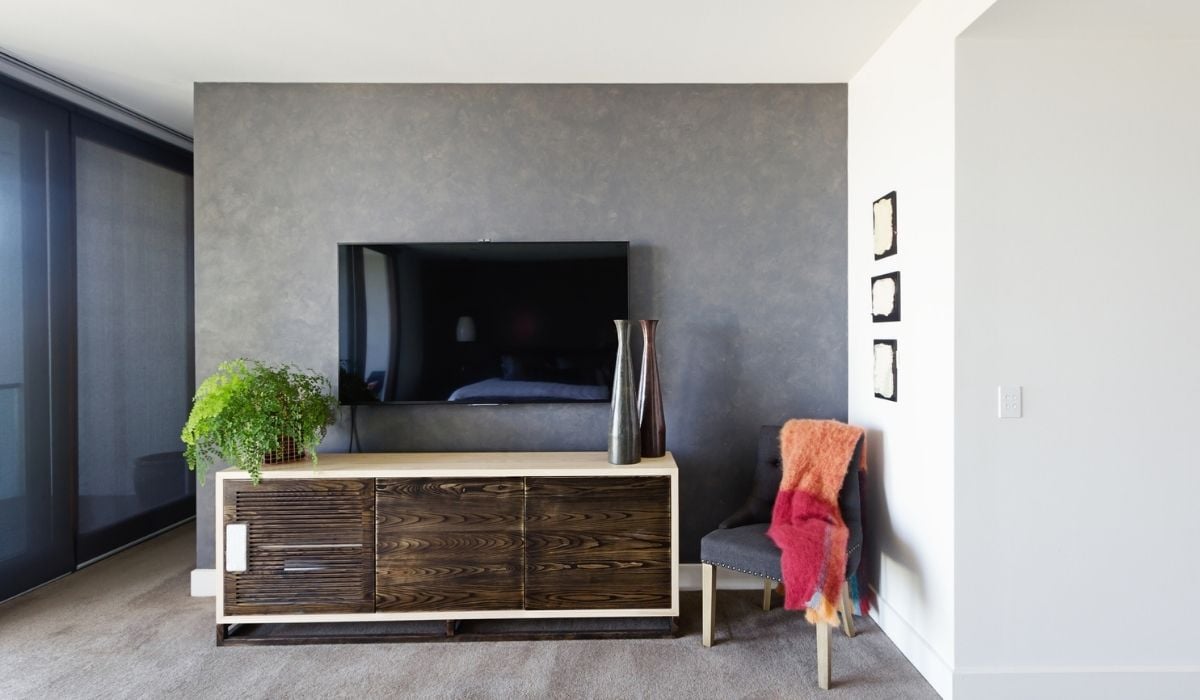 Wall mounted tv and buffet in spacious master bedroom