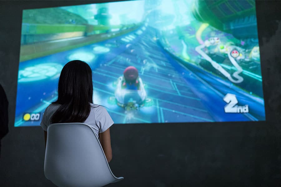 Woman Playing Mario Kart 8 on Nintendo - Canva - Smaller