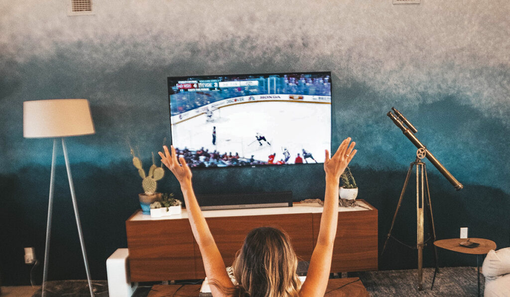 Woman watching hockey on tv