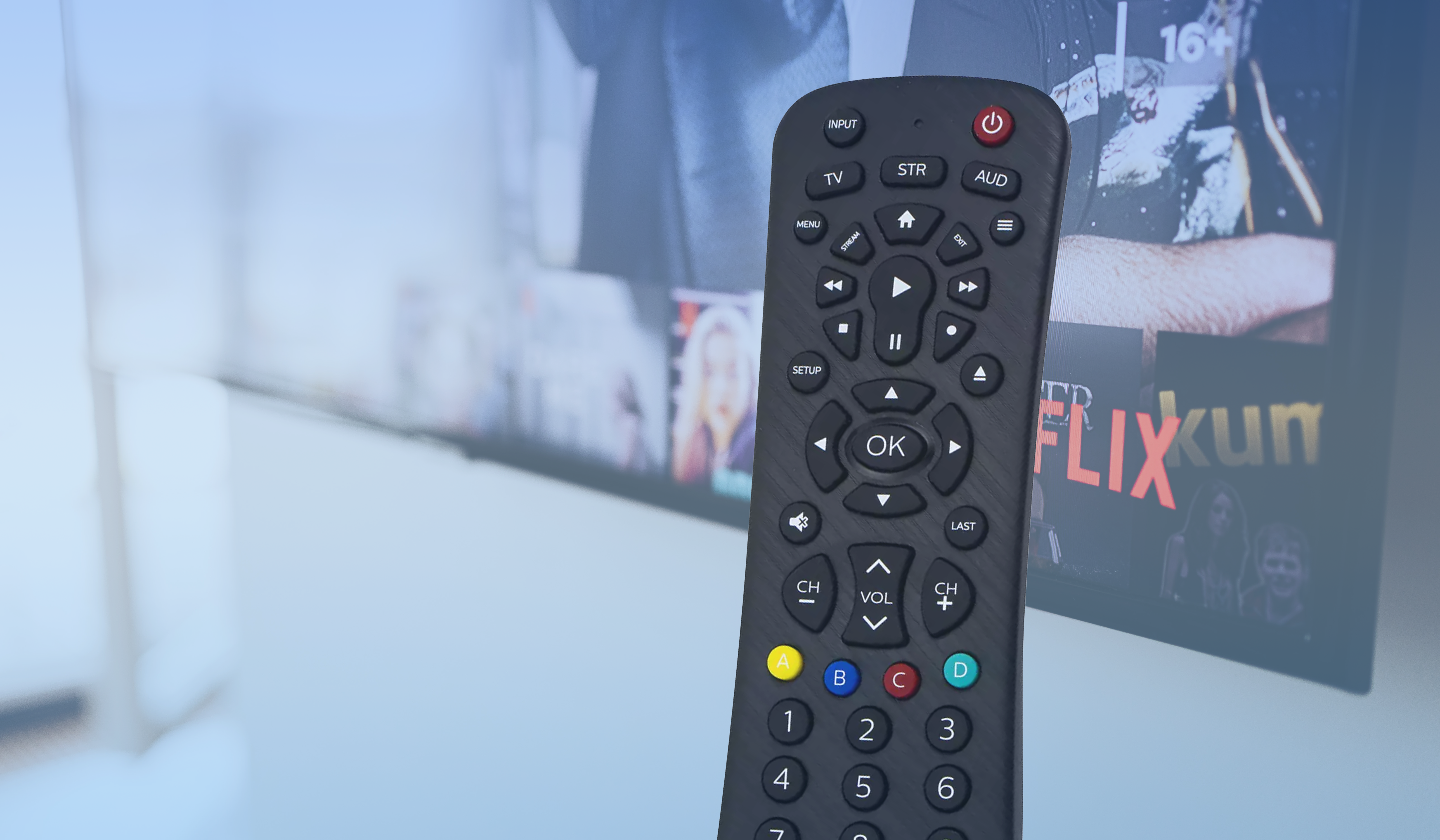 A Philips Universal Remote in front of a TV displaying Netflix