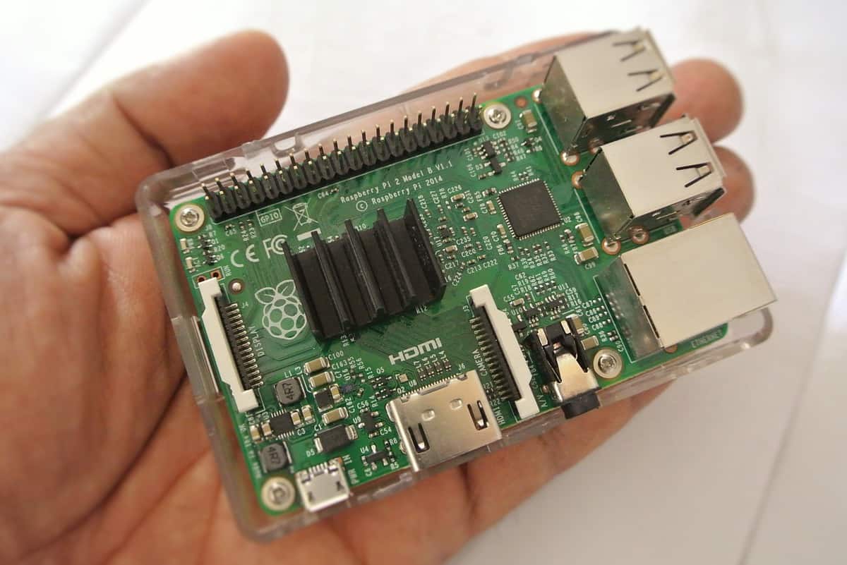 A Raspberry Pi 2 Model B, held in someone's hand.