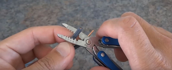 wire stripper with notches indicating AWG on the inside of its blades