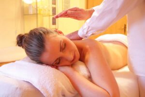 Woman relaxing at a spa, having a back massage