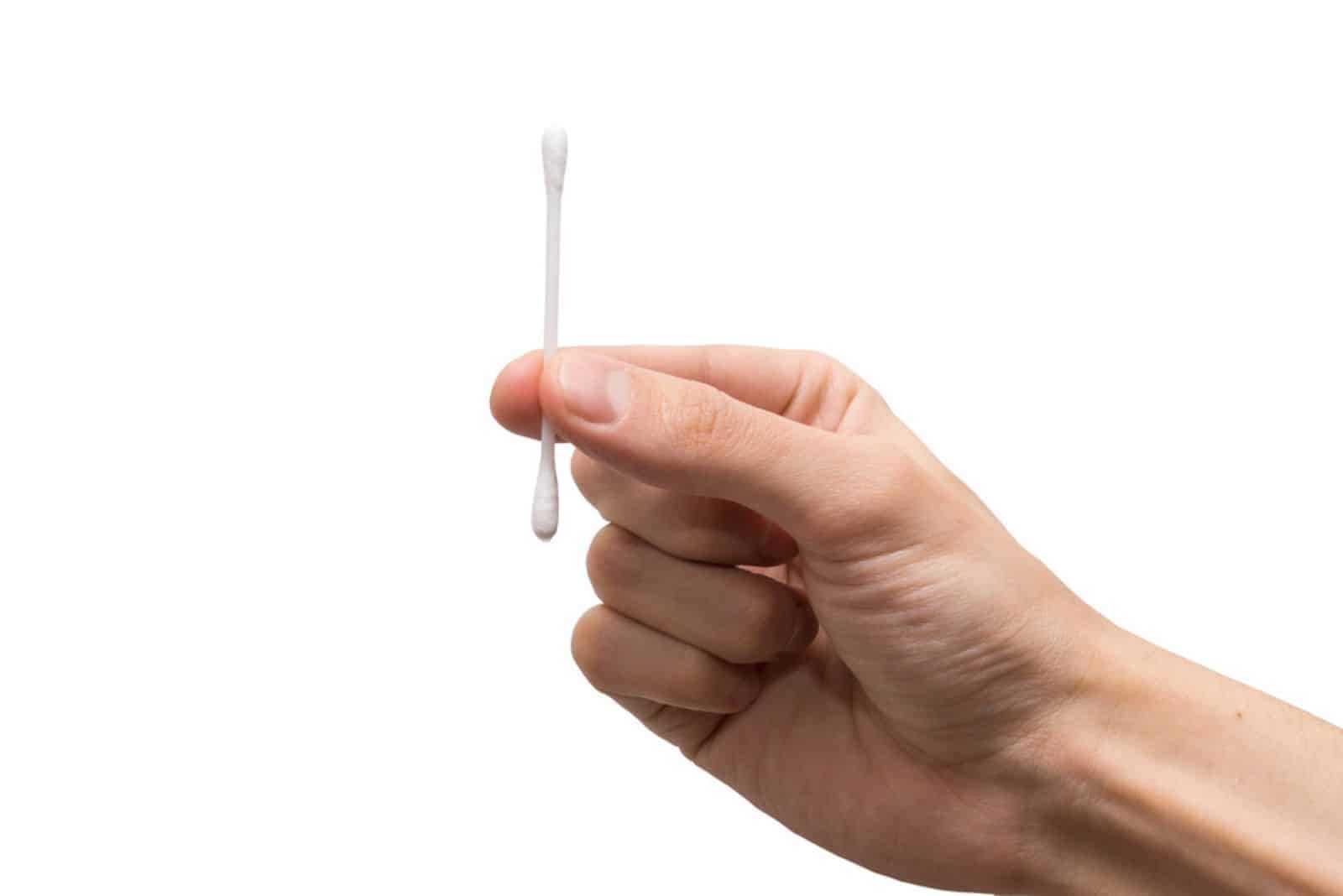 Hand with a cotton swab