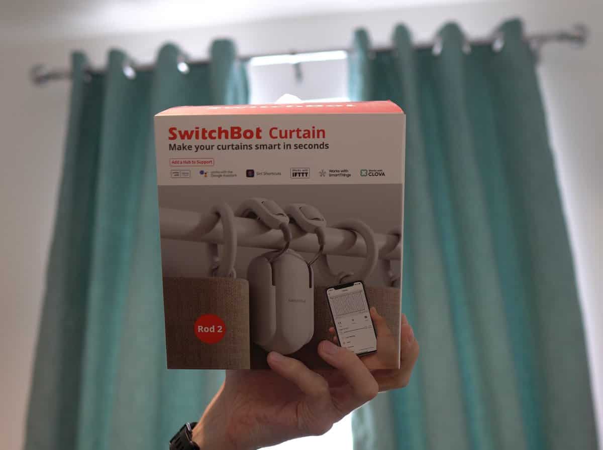 Me holding the SwitchBot Curtain product