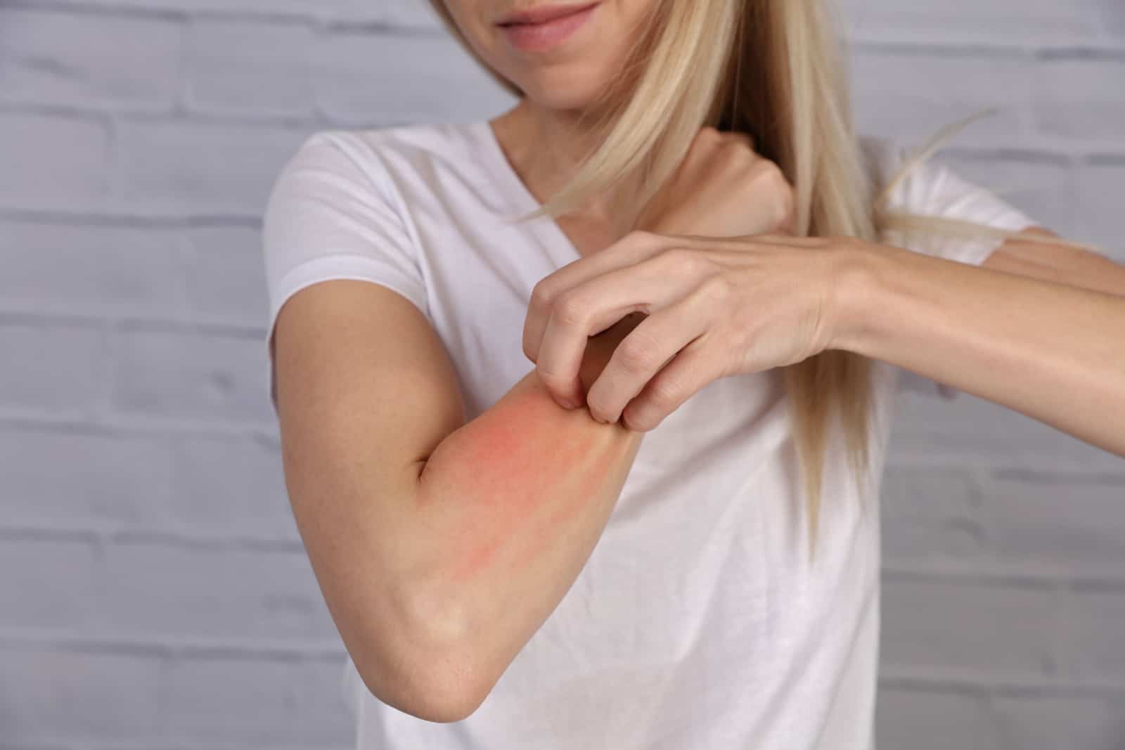 Woman Scratching an itch on white background