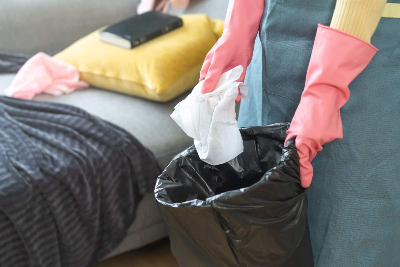 a woman buys trash in a bin