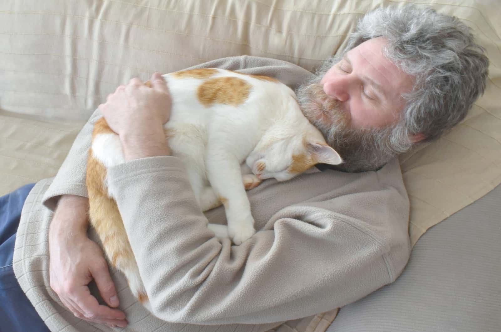 cat lying on older man's chest