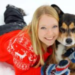 Woman Hugging German Shepherd Husky Mix Dog in Snow