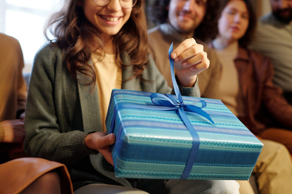 photo of a homeowner opening a housewarming gift