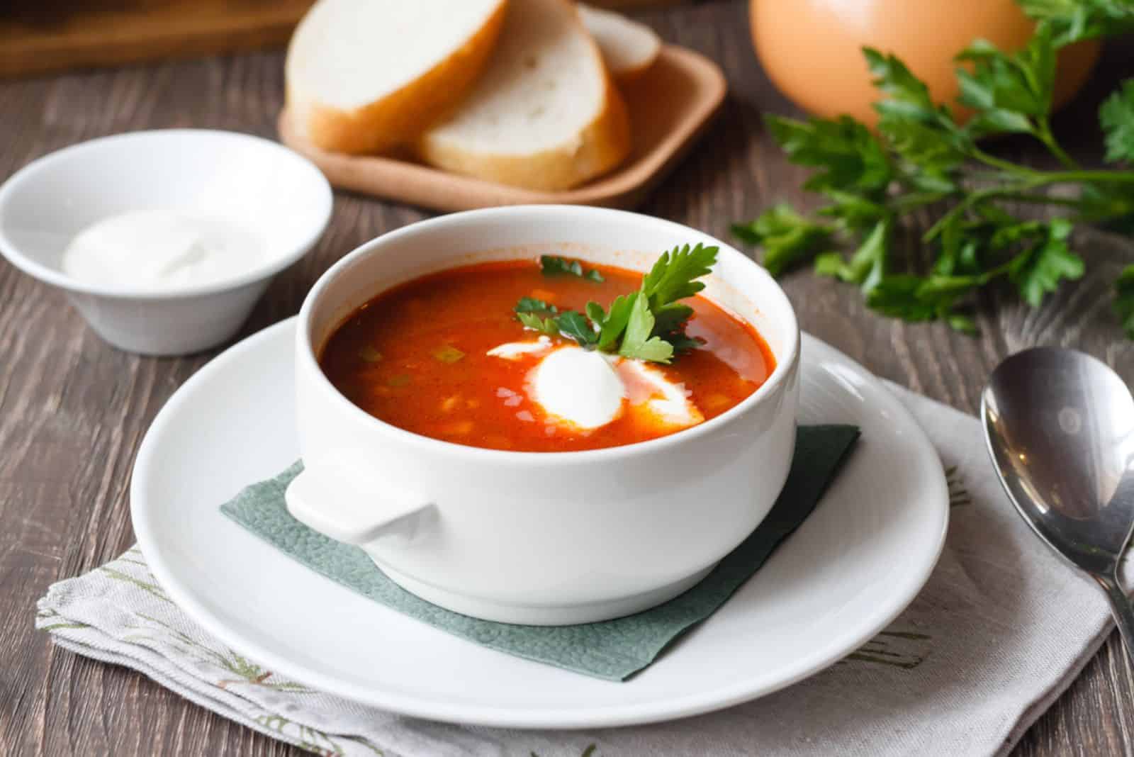 red soup with sour cream and greens