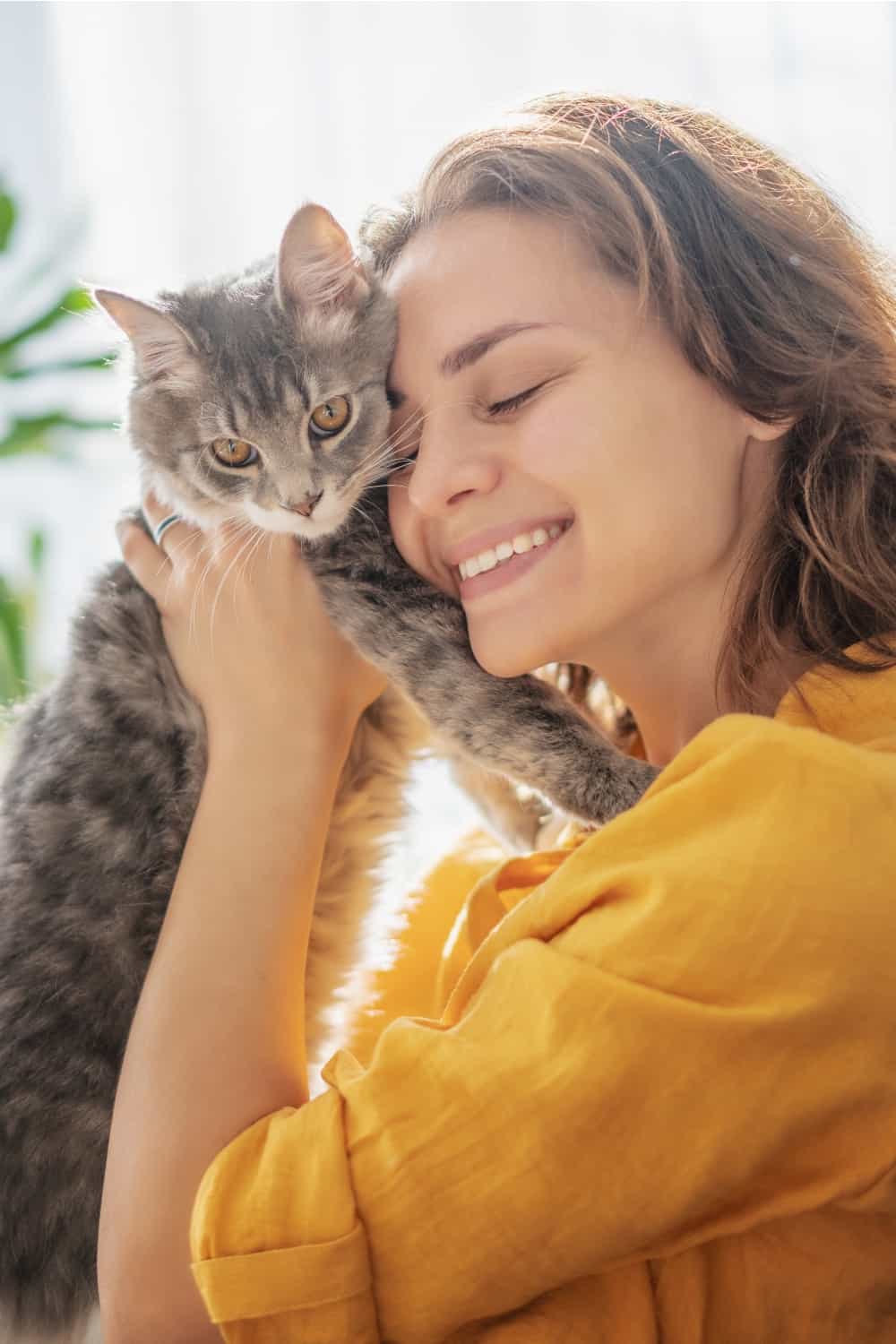 woman and cat cuddling