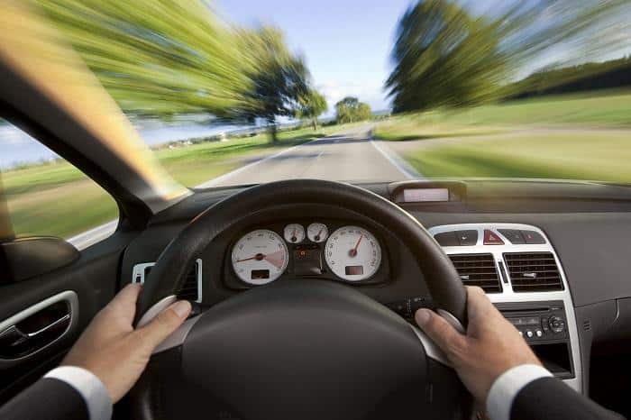 Man in suit driving a car from vehicle interior