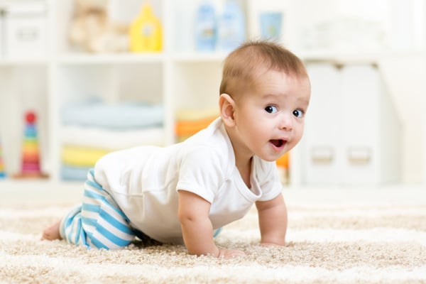 Baby crawling in a nursery