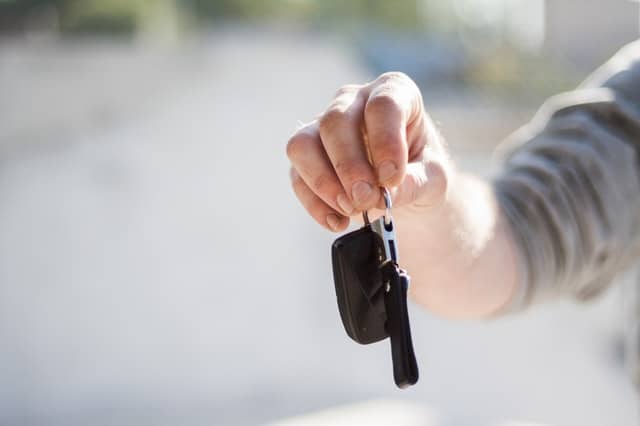 man holding a car key