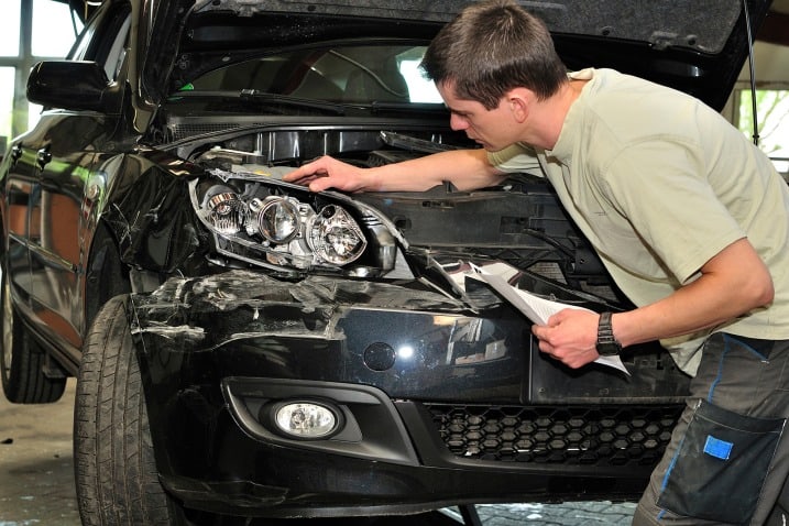 man fixing a car