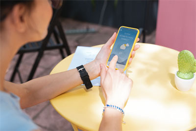 A woman checking the forecast on a weather app