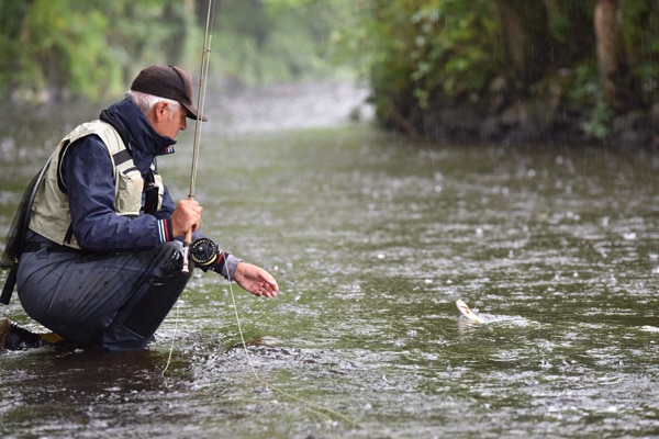 Man fishing in the rain