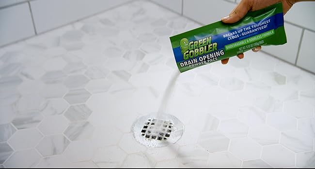 photo of a person using Green Gobbler drain cleaner