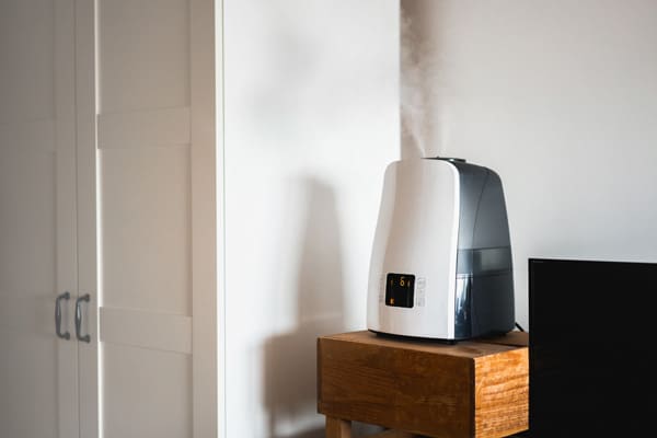 Humidifier placed up high on a bench at home