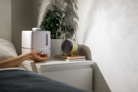 Humidifier positioned in bedroom on table