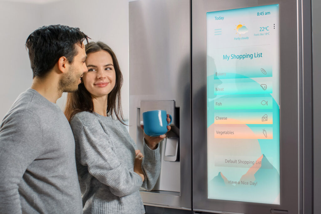 photo of a happy couple admiring their smart fridge