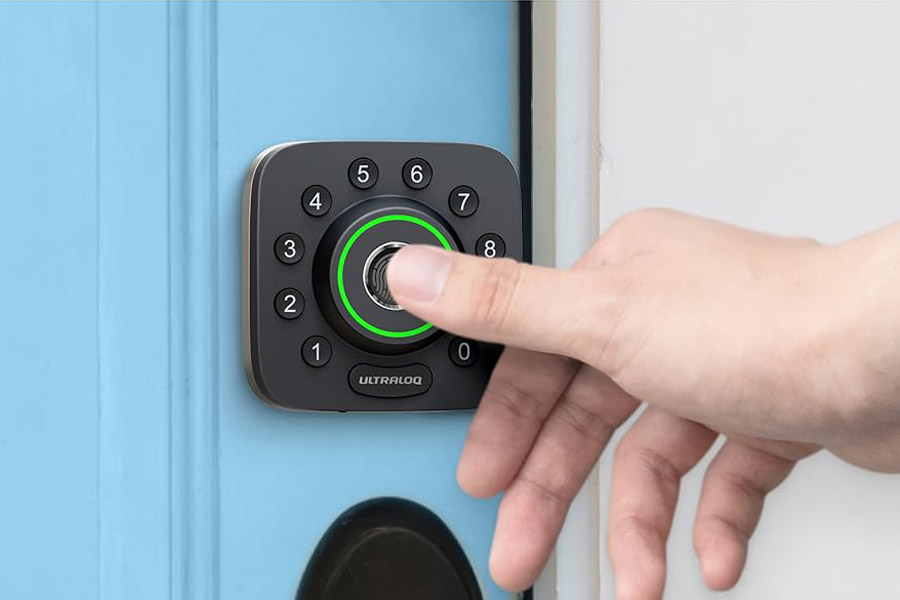 photo of a homeowner using a smart lock on the front door