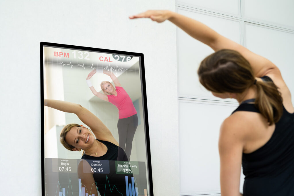 photo of a woman exercising in front of a smart mirror