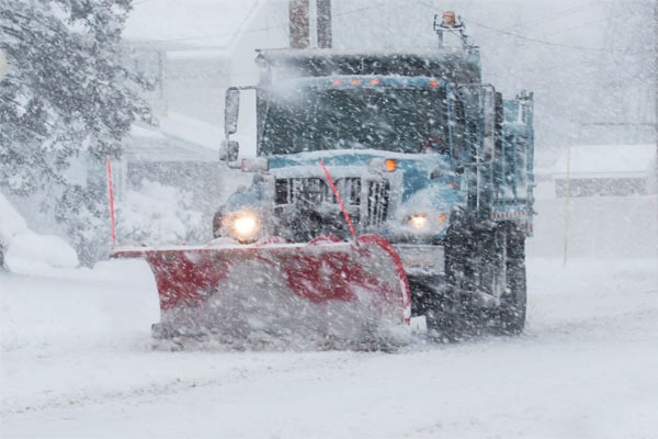 Snow plow removing snow from a road