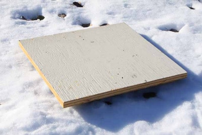 Snowboard being used to measure snow