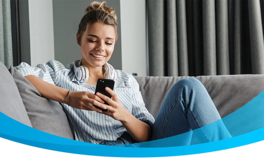 photo of a woman enjoying her upgraded smartphone from AT&T Next Up